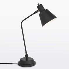 a black desk lamp on a white background