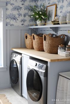 a washer and dryer sitting on top of a counter in a laundry room