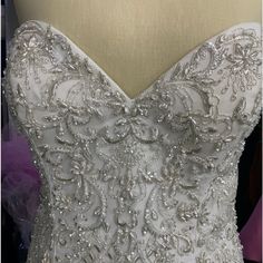 the back of a wedding dress with beading on it's bounches