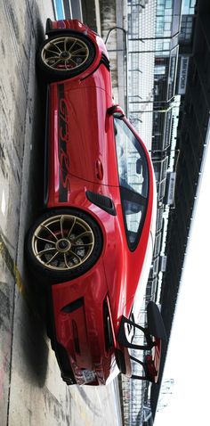 a red sports car parked on the side of a building