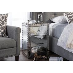 a bed sitting next to a gray couch in a bedroom