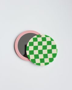 two green and white checkered coasters sitting next to each other