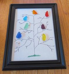 a framed artwork with birds sitting on a tree branch in the shape of a family tree