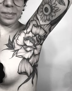 a woman's arm with sunflowers and roses tattoo on her left arm