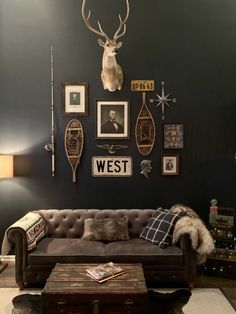 a living room filled with furniture and pictures on the wall