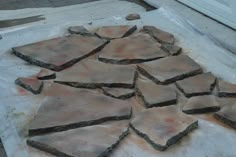 several pieces of stone sitting on top of a piece of white paper next to a door