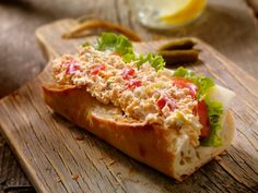 a sandwich with meat and lettuce on a cutting board