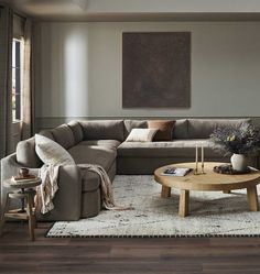 a living room with a sectional couch and coffee table