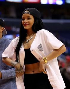 a woman standing next to a man on top of a basketball court