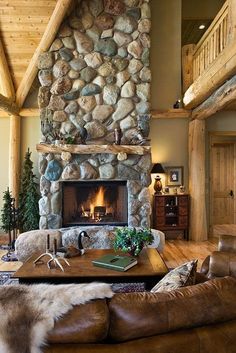 a living room with stone fireplace and leather couches