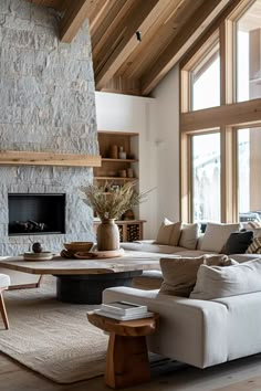 a living room filled with furniture and a fire place in the middle of a room