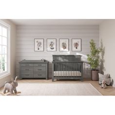 a baby's room with gray furniture and pictures on the wall