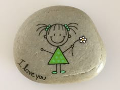 a rock with a drawing of a girl holding a flower and the words i love you on it