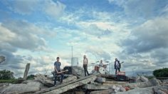 a group of people standing on top of a pile of rocks