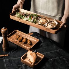 a person holding a tray with food on it