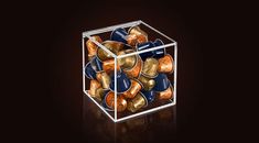 a glass box filled with lots of gold and blue coins on top of a black surface