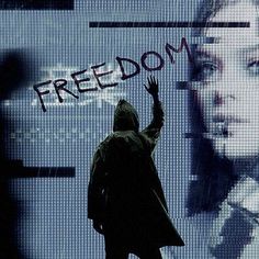 a man standing in front of a screen with the word freedom written on it and someone holding their hand up