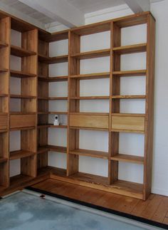 an empty room with wooden shelves in it