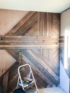 a ladder sitting next to a wall with wood paneling on it's sides