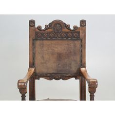 an old wooden chair with ornate carvings on the back