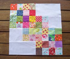 a patchwork quilt on a wooden table