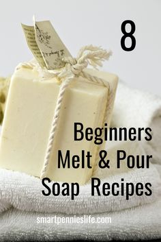 a soap bar sitting on top of a white towel next to a pile of towels