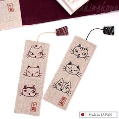 two bookmarks with cats drawn on them