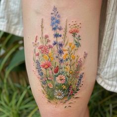 a woman's thigh with flowers painted on it