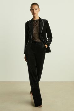 Made from premium plush velvet, the Parisa trousers fit relaxed against the body. Their slim profile flares out at the hem and satin details the side seams. Matching waistcoat and blazer. Velvet construction. Satin side stripes. Flared leg Velvet Trouser Suit Women, Tailored Velvet Evening Suits, Black Fitted Velvet Suit, Trouser Suit Women, Semi-formal Black Velvet Suit, Fitted Velvet Single-breasted Suits, Tailored Single Breasted Velvet Suit, Flared Suit, Velvet Flares