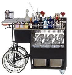 a bar cart with wine glasses and liquor bottles