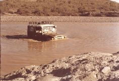 an old truck is stuck in the water