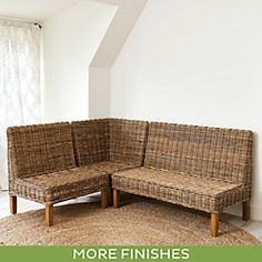 a wicker couch sitting on top of a rug