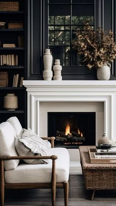 a living room filled with furniture and a fire place in the middle of it's fireplace