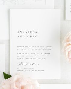 the wedding stationery is laid out with pink flowers