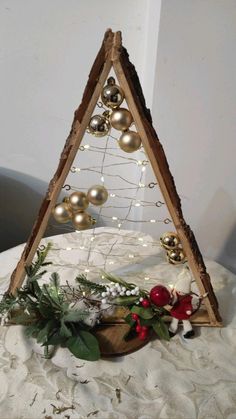 a triangle shaped christmas tree with ornaments on it