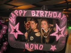 two young women standing in front of a photo frame that says happy birthday nono