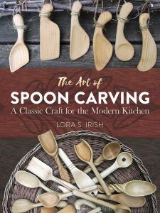 the art of spoon carving by lora s irish paperback book cover with wooden spoons and kitchen utensils