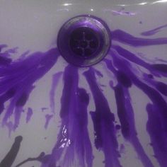 a sink that has some purple paint on it