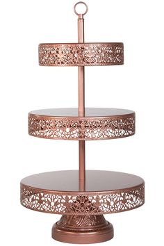 three tiered metal cake stand with intricate designs on the sides and round base, set against a white background