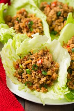 a plate filled with lettuce covered in meat