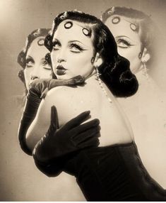 an old photo of three women with makeup on their faces and hands in front of them