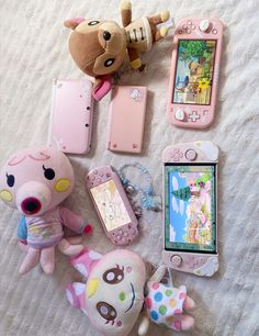 there are many toys and cell phones on the bed