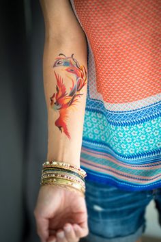 a woman with a colorful tattoo on her arm