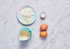 eggs, flour and other ingredients on a marble surface