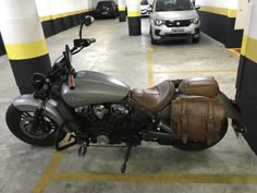 a motorcycle parked in a parking garage next to a car