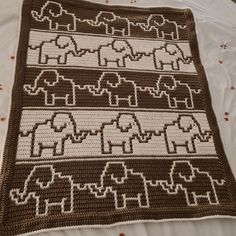 a crocheted blanket with elephants on it