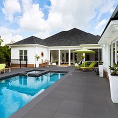 a large pool in front of a white house