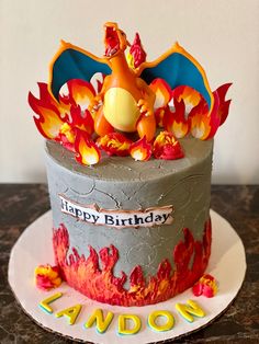 a birthday cake with a pokemon figure on top