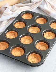 a muffin tin filled with cupcakes on top of a white countertop