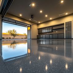 an empty garage with lights on the ceiling and doors open to let in plenty of light